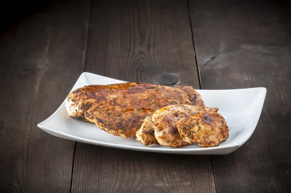 Grilled chicken breast on white plate — Stock Photo, Image