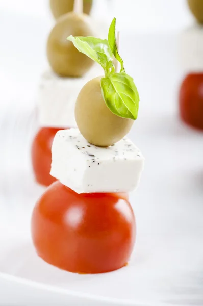 Small appetizer with tomato, feta cheese and olives — Stock Photo, Image