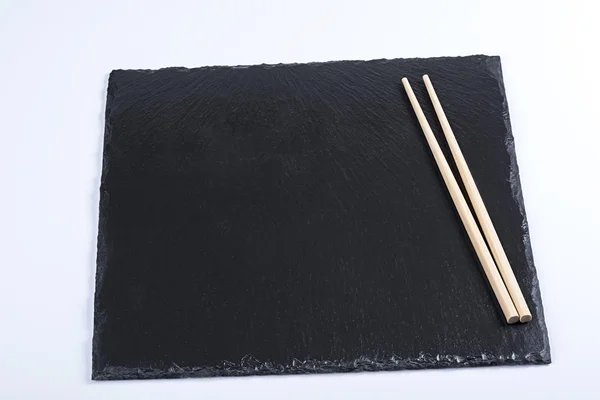 Stone plate and chopsticks — Stock Photo, Image