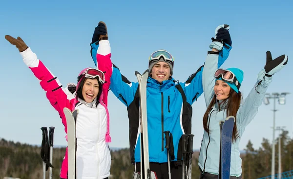 Half-length portrait of group of alps skier friends with hands up — Stock Photo, Image