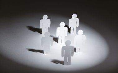 Group of papermen in the light clipart