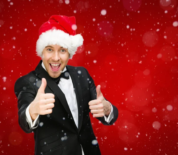 Uomo d'affari che indossa Babbo Natale cap pollici in su — Foto Stock