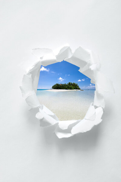 Paper hole with tropical beach scenery