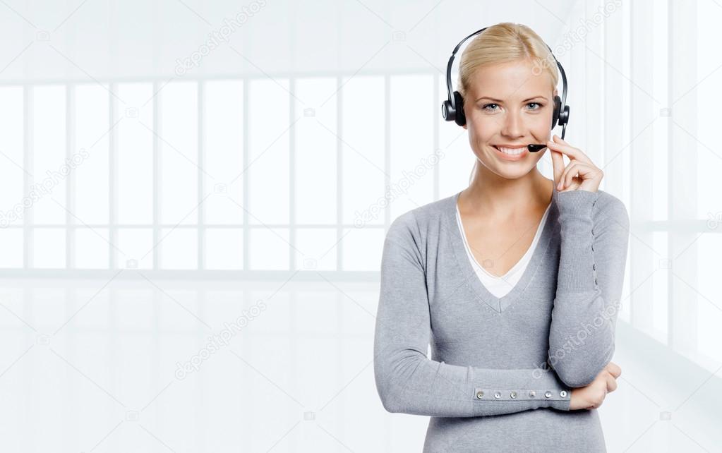 Woman speaking on the earphone in office
