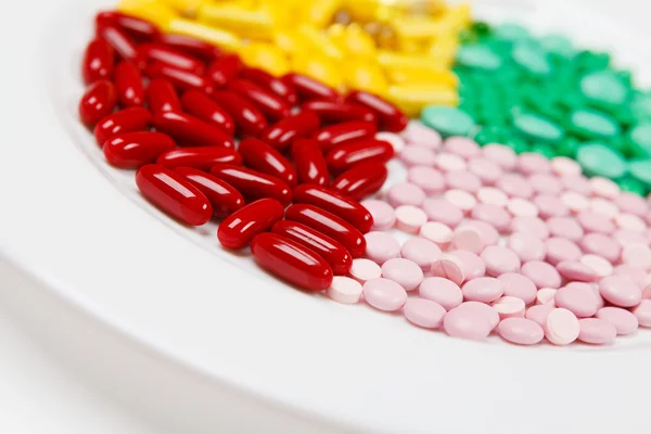 Vitamins on the white plate — Stock Photo, Image