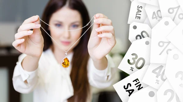 Woman keeping necklace with sapphire — Stock Photo, Image