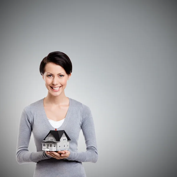 Holding small toy house in front of herself — Stock Photo, Image