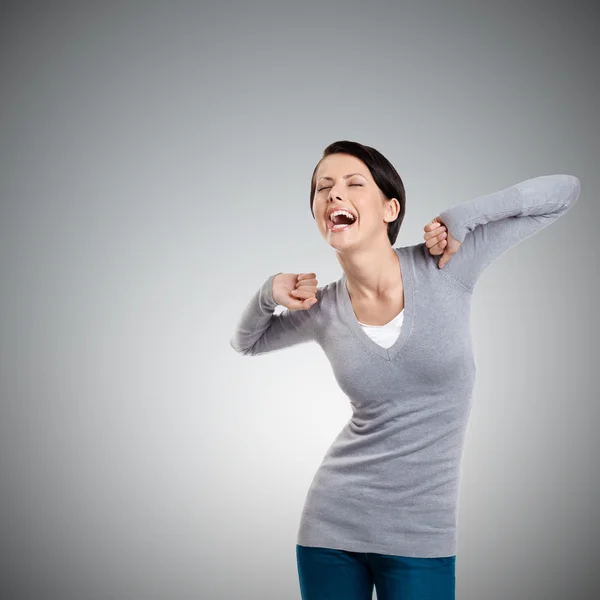 Laughing woman stretches herself — Stock Photo, Image