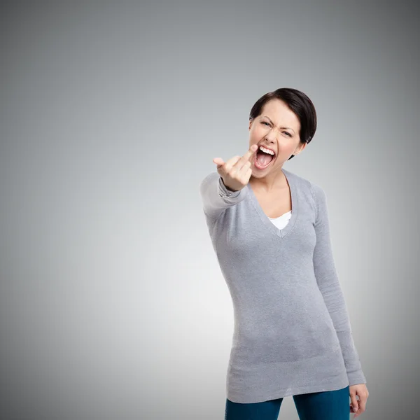 Attractive woman shows a vulgar finger sign — Stock Photo, Image