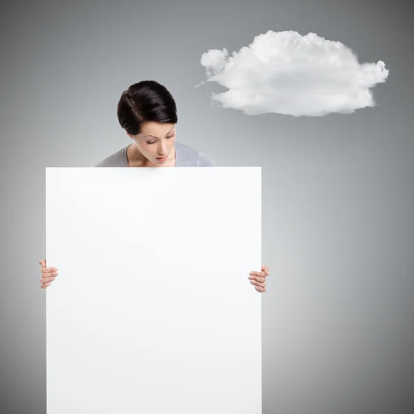 Woman brings a huge sheet of white cardboard — Stock Photo, Image