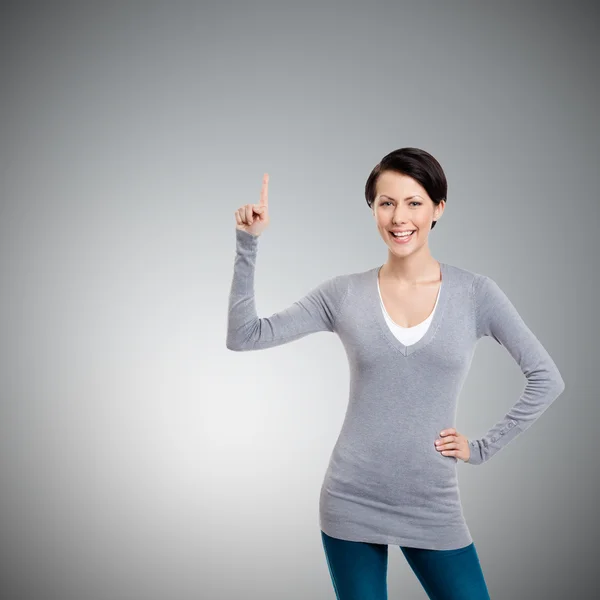 Frau zeigt Zeigefinger, Aufmerksamkeitszeichen — Stockfoto