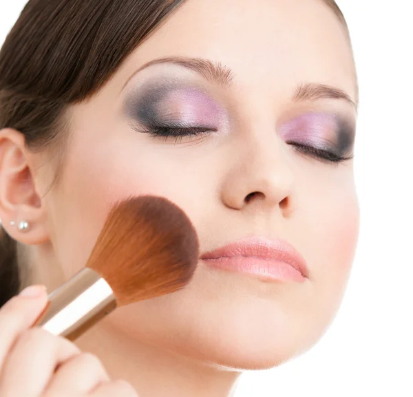 Woman applying cosmetics to her face — Stock Photo, Image