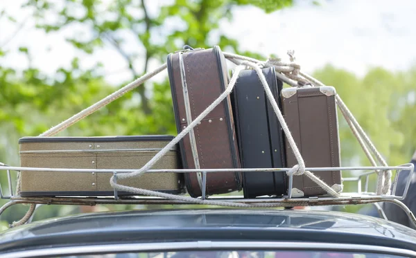 Suitcases on the roof of the trunk of a car. Stock Photo