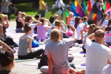 Belarus, Minsk, 2016. Uluslararası yoga günü festivali sırasında parkta egzersiz yapan insanlar