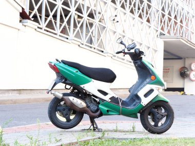 Belarus, Minsk, 2021 model motor yağı şehirdeki bir scooterın arka planında.