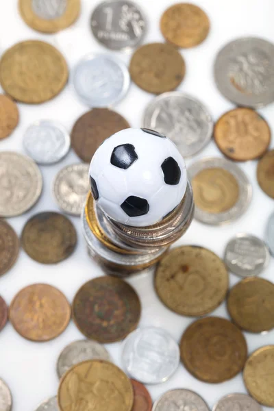 Soccer ball and coins — Stock Photo, Image