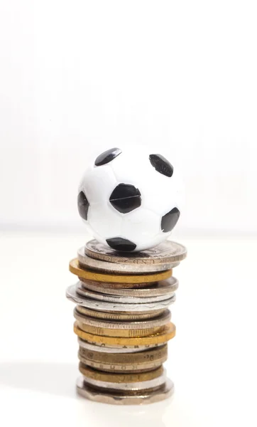 Soccer ball and coins — Stock Photo, Image