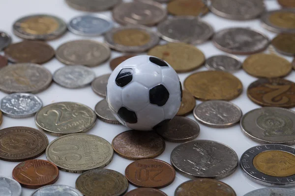 Soccer ball and coins — Stock Photo, Image