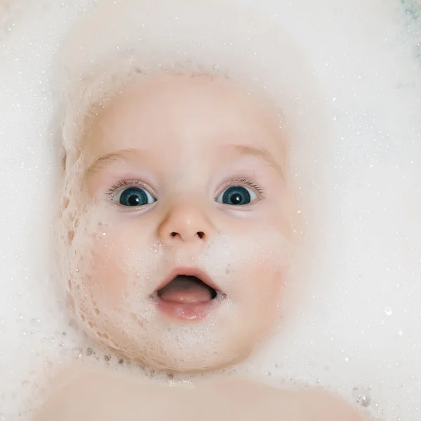 Baby bathing in a bathtub