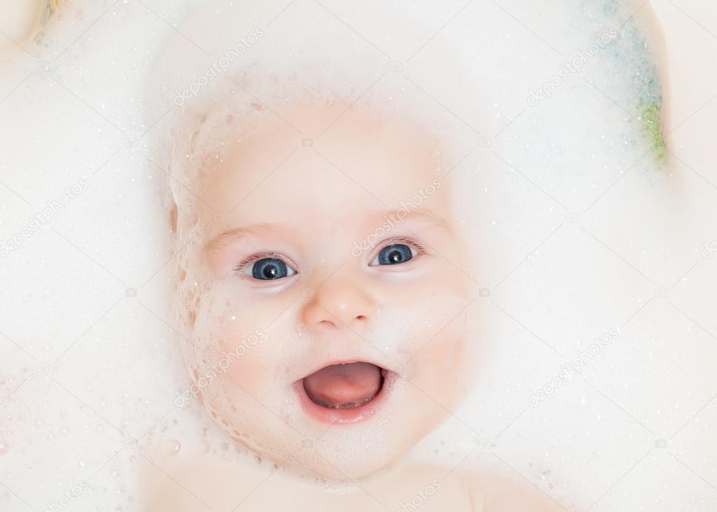 Baby bathing in a bathtub