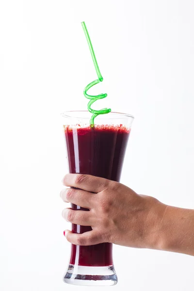 Glass of juice in hand — Stock Photo, Image