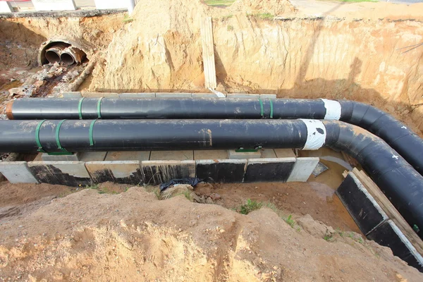 Pipes for water in trench — Stock Photo, Image