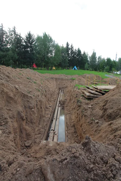 Pipes for water in trench — Stock Photo, Image