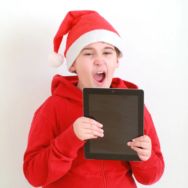 Boy in Santa hat with tablet — Stock Photo, Image