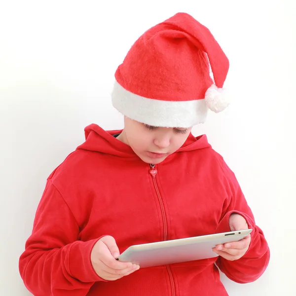 Boy in Santa hat with tablet — Stock Photo, Image
