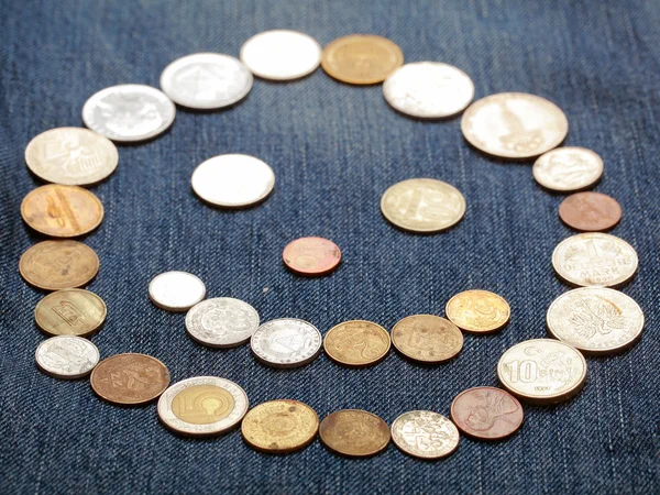 Smile from coins on blue — Stock Photo, Image