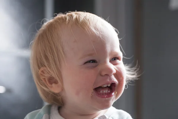 Child eats porridge from a spoon — Stock Photo, Image