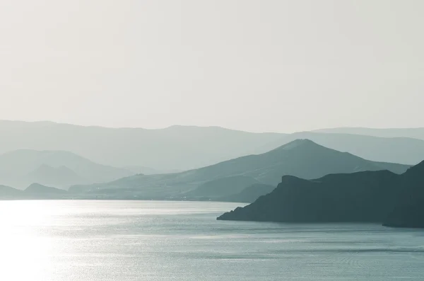 Морський пейзаж з горами і сонцем — стокове фото