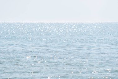 Abstract minimalistic natural background with blue sea water, highlights and ripples