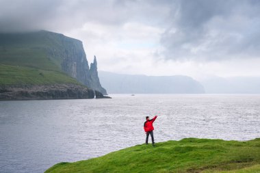 Vagar Adası, Faroe Adaları 'ndaki Trollkonfingur ya da Cadıların Parmağı kaya sütununa bakan selfie
