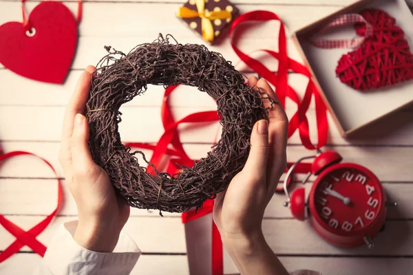 Female hands holding a wreath — Stock Photo, Image