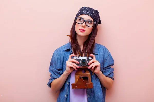 Portrait of a young woman with camera — Stock Photo, Image