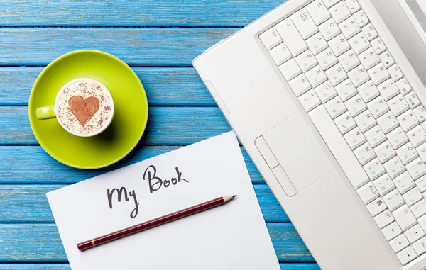 Paper, coffee and laptop lying on the table — Stock Photo, Image