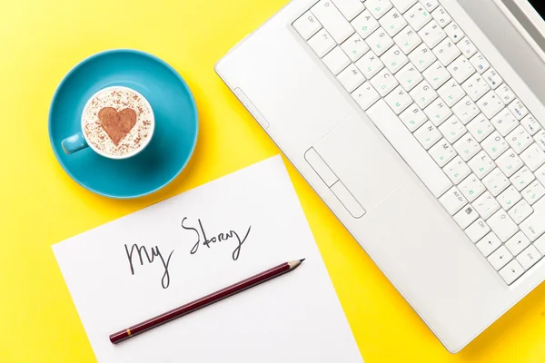 Paper, pencil, laptop and cup lying on the table — Stock Photo, Image