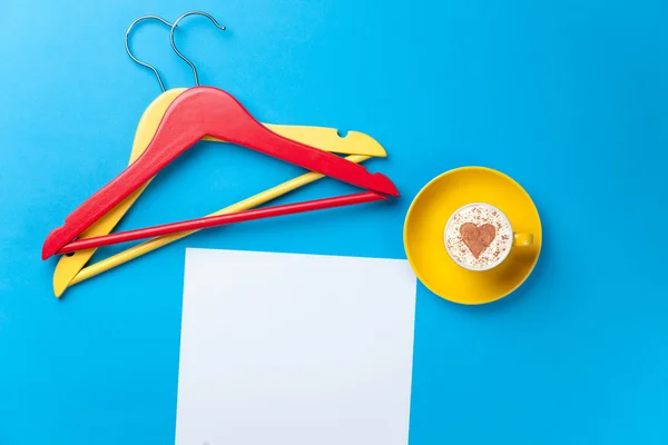 Cup and hangers lying on the table — Stock Photo, Image