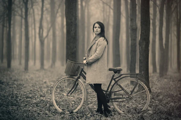 Portrait of a young woman with a bicycle — Stock Photo, Image