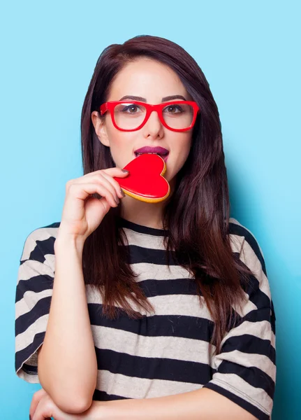 Portrait of a young woman with cookie — Stock Photo, Image