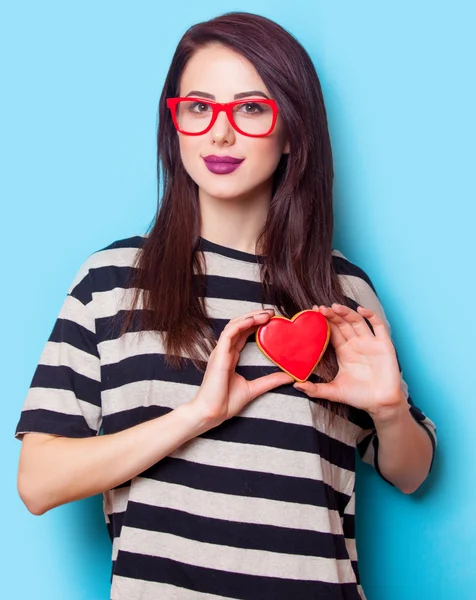 Portrait of a young woman with cookie — Stock Photo, Image