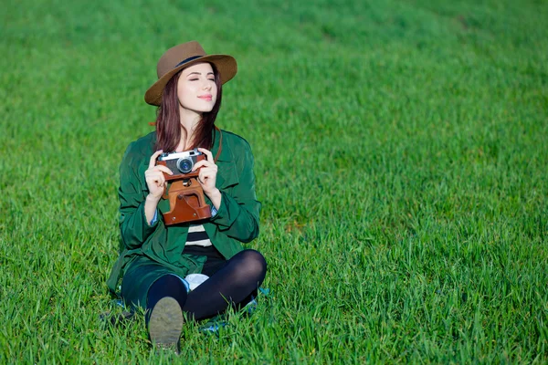 Portrait of young woman with camera — Stock Photo, Image