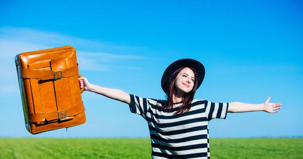 Portrait of young woman with suitcase — Stock Photo, Image
