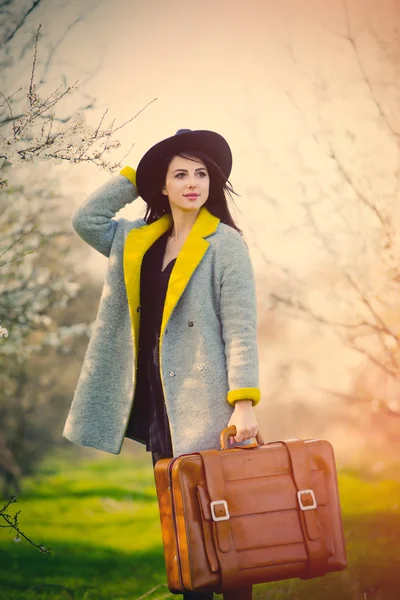 Portrait of young woman with suitcase — Stock Photo, Image