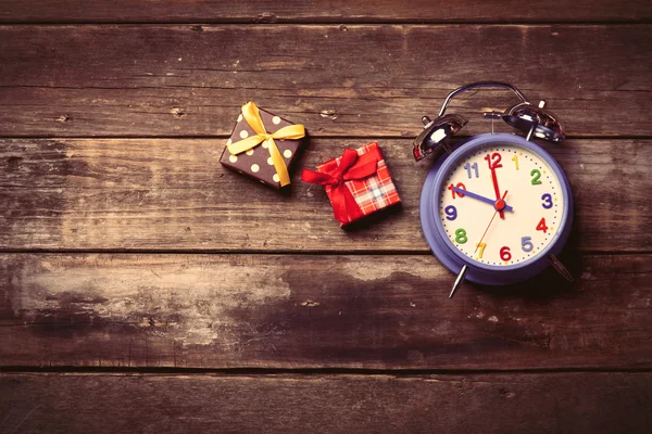Hadiah dan jam di atas meja — Stok Foto