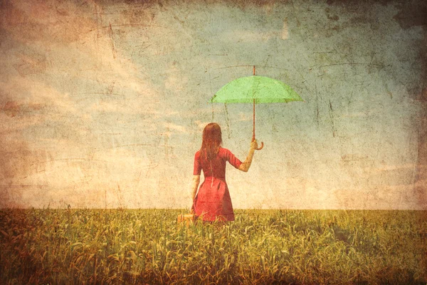 Young woman with suitcase and umbrella — Stock Photo, Image