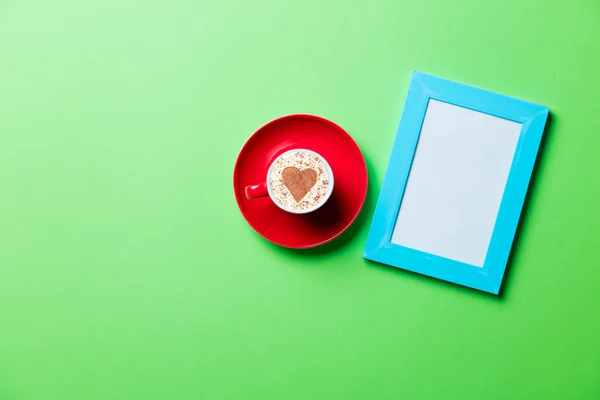 Cup and photo frame — Stock Photo, Image