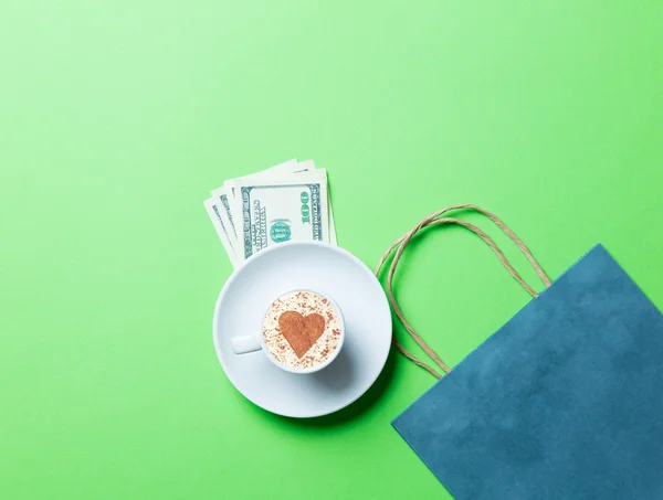 Cup, boodschappentas en geld — Stockfoto