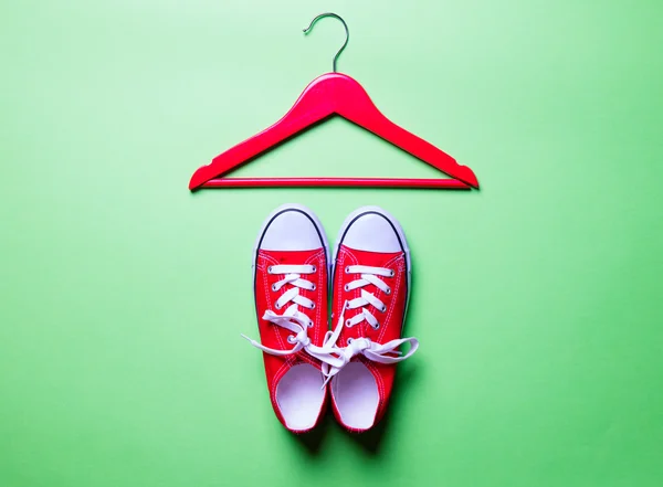 Red gumshoes and hanger — Stock Photo, Image